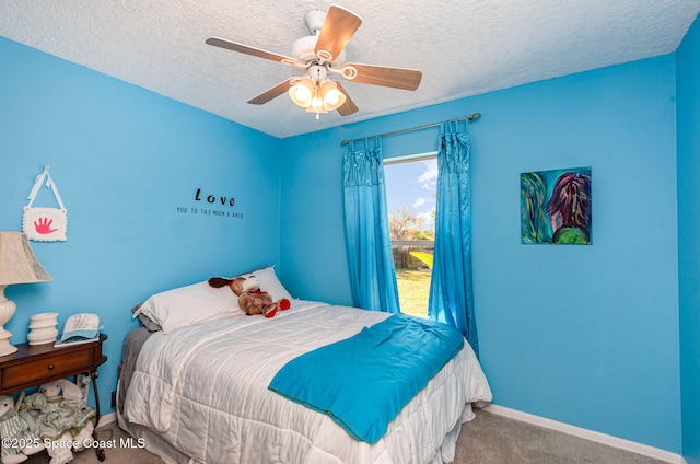 carpeted bedroom featuring ceiling fan and a textured ceiling