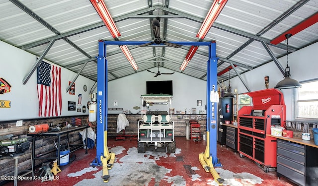 garage with a workshop area and ceiling fan