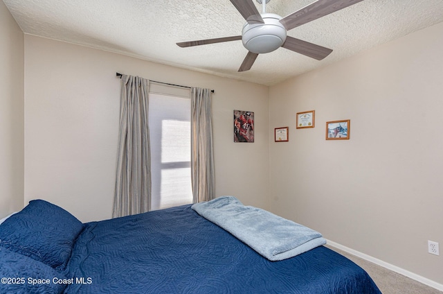 carpeted bedroom with ceiling fan and a textured ceiling