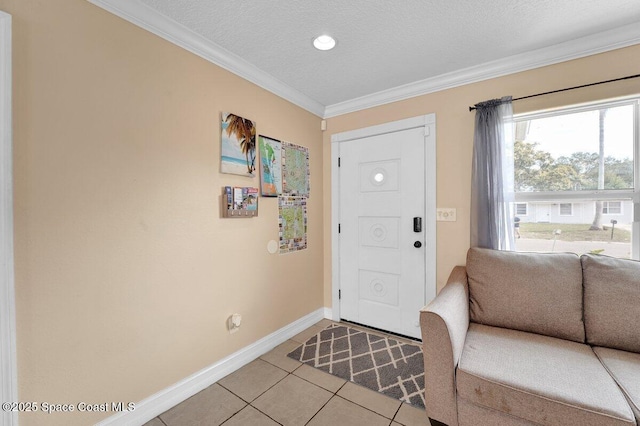 entrance foyer featuring light tile patterned floors, crown molding, and a textured ceiling