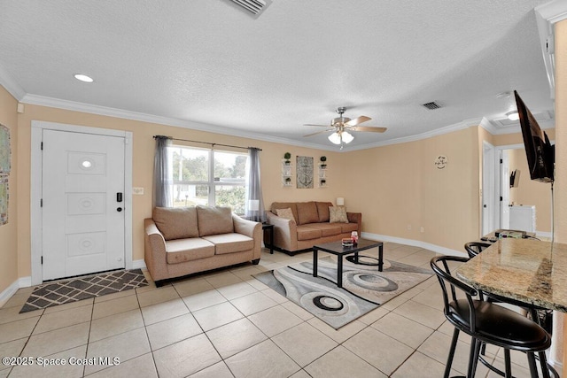 tiled living room with ceiling fan, crown molding, and a textured ceiling