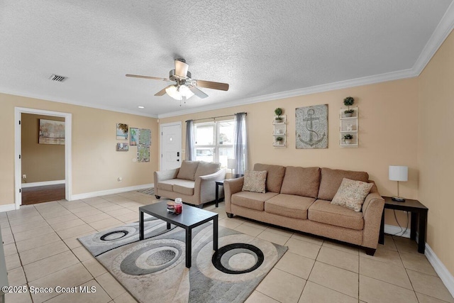 living room featuring ornamental molding, light tile patterned floors, ceiling fan, and a textured ceiling