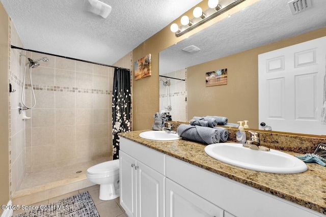 bathroom with tile patterned flooring, vanity, toilet, a textured ceiling, and a shower with curtain