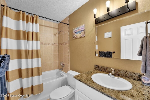 full bathroom with shower / tub combo with curtain, vanity, toilet, and a textured ceiling