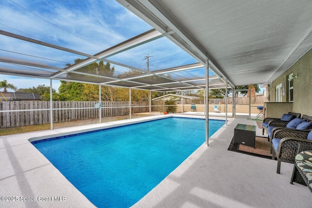 view of swimming pool featuring a lanai, an outdoor hangout area, and a patio