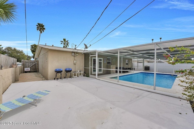 view of swimming pool with a lanai and a patio area