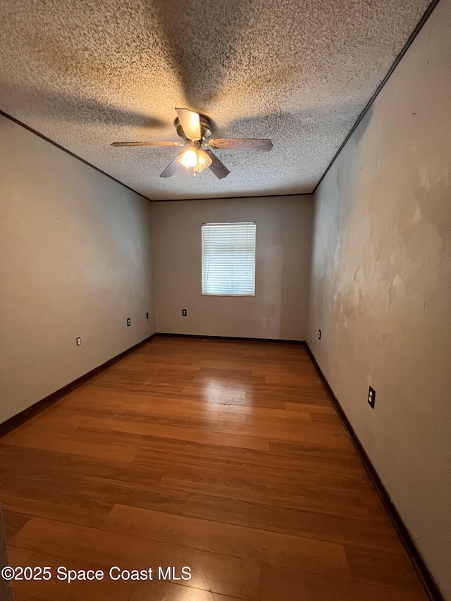 unfurnished room with hardwood / wood-style flooring, a textured ceiling, and ceiling fan