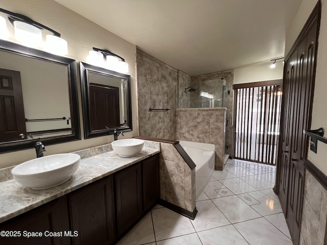 bathroom featuring independent shower and bath, tile patterned floors, and vanity