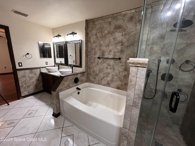 bathroom with vanity, tile walls, separate shower and tub, and tile patterned flooring