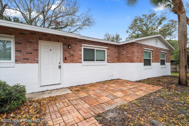 entrance to property with a patio