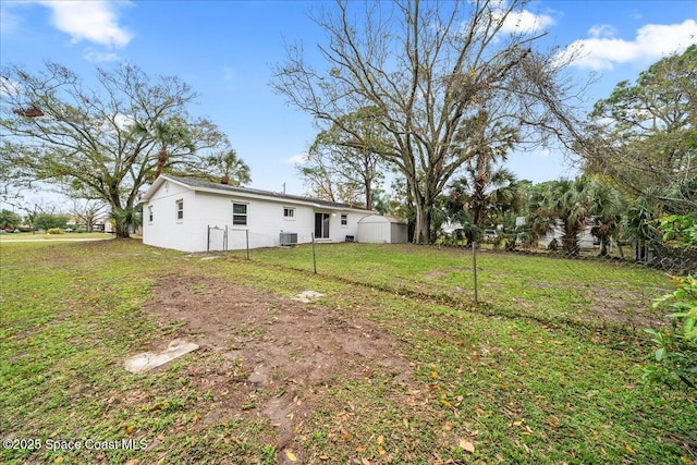 view of yard with cooling unit and fence