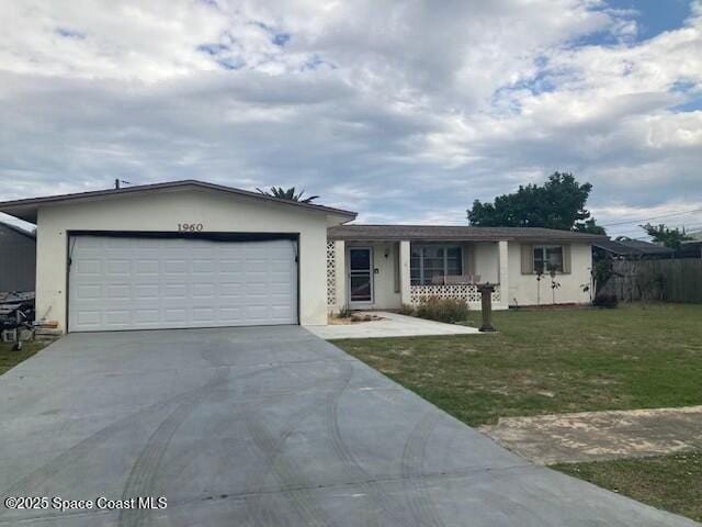 ranch-style house with stucco siding, concrete driveway, a front yard, fence, and a garage