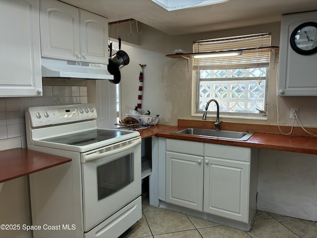 kitchen with under cabinet range hood, a sink, backsplash, white cabinetry, and white electric stove