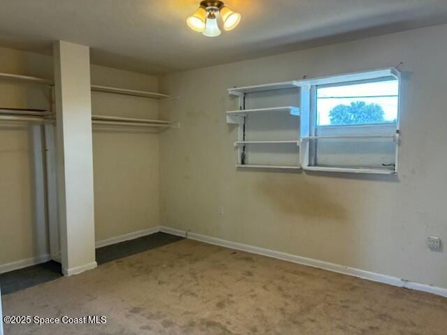 unfurnished bedroom with carpet and baseboards