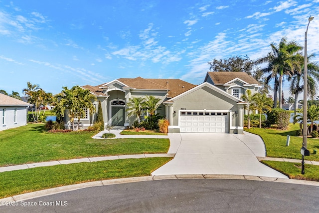 view of front of home with a garage and a front yard