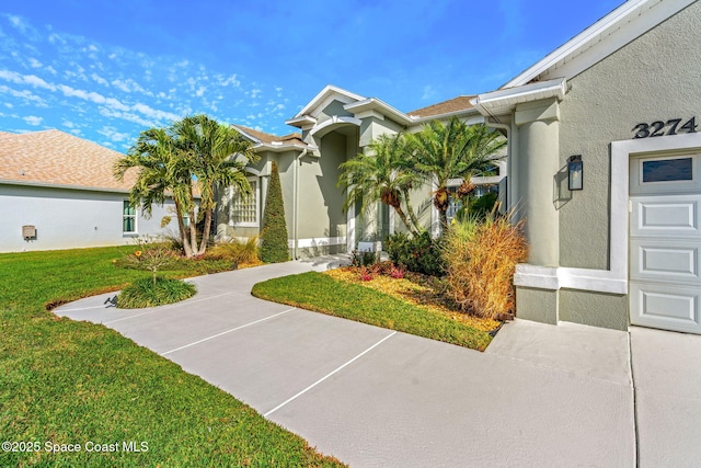 view of front of home with a garage and a front yard