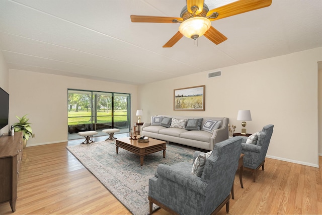 living room featuring light wood-type flooring and ceiling fan