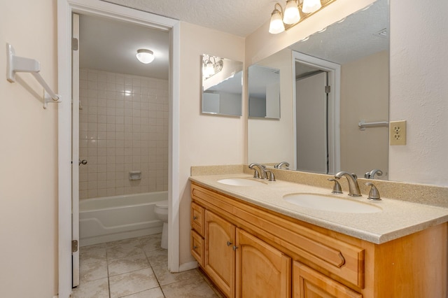 full bathroom with tiled shower / bath combo, tile patterned floors, vanity, and toilet