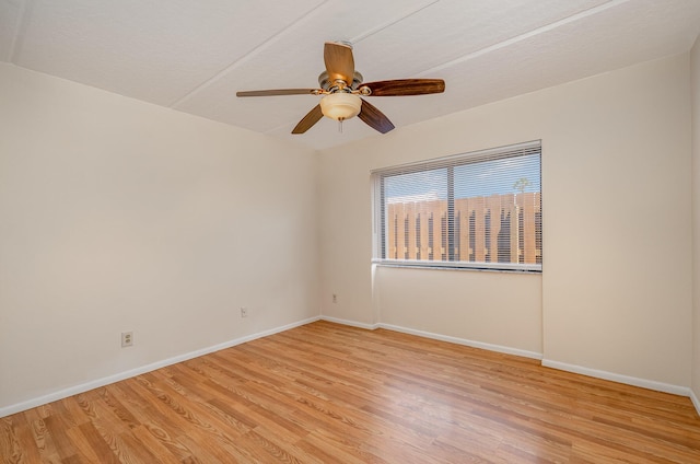 empty room with light wood-type flooring and ceiling fan