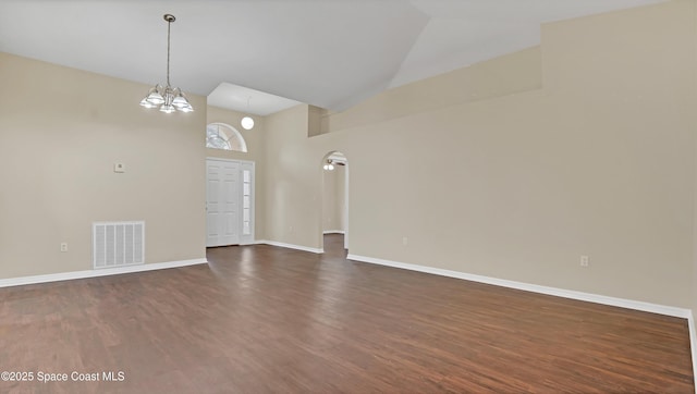 unfurnished living room featuring a notable chandelier, high vaulted ceiling, and dark hardwood / wood-style flooring