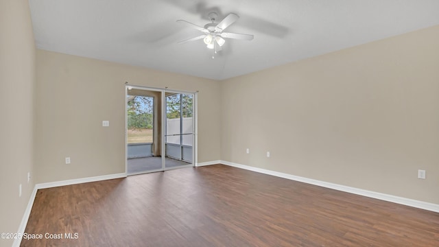 spare room featuring dark wood-type flooring and ceiling fan