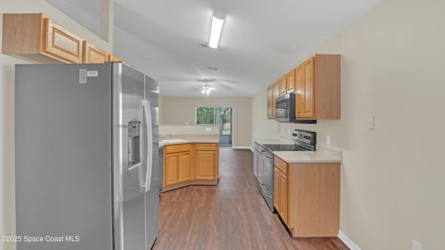 kitchen featuring dark hardwood / wood-style floors, light brown cabinetry, appliances with stainless steel finishes, and a textured ceiling