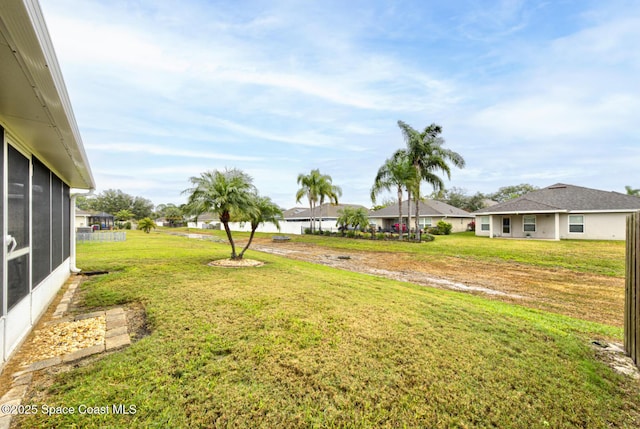 view of yard featuring a sunroom