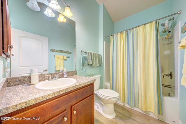 full bathroom with a notable chandelier, toilet, shower / bath combo with shower curtain, hardwood / wood-style flooring, and vanity