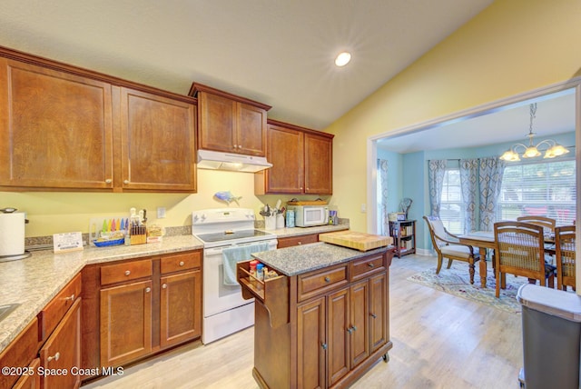 kitchen featuring white appliances, light wood-type flooring, vaulted ceiling, and light stone counters