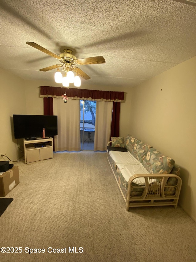 interior space featuring ceiling fan, carpet flooring, and a textured ceiling