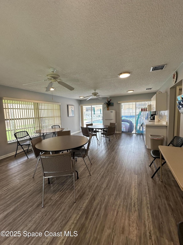 dining space featuring hardwood / wood-style flooring and a textured ceiling