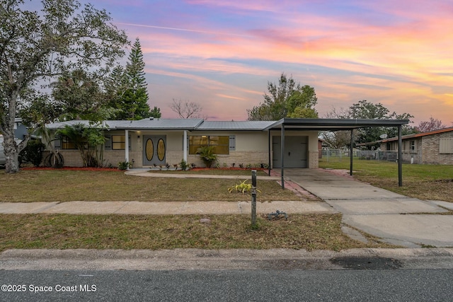 view of front of property featuring a yard and a carport