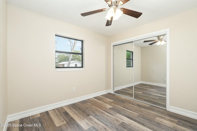 unfurnished bedroom featuring ceiling fan, hardwood / wood-style floors, and a closet