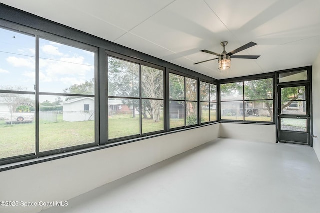 unfurnished sunroom featuring ceiling fan