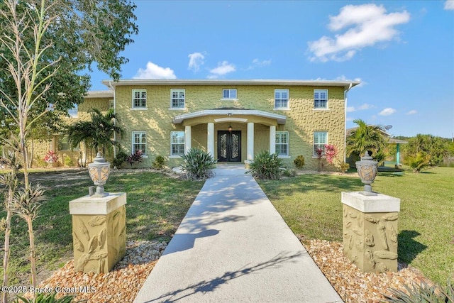 view of front facade featuring french doors and a front yard