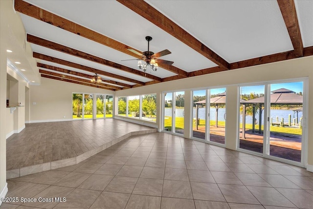 interior space with lofted ceiling with beams, light tile patterned flooring, a water view, and ceiling fan