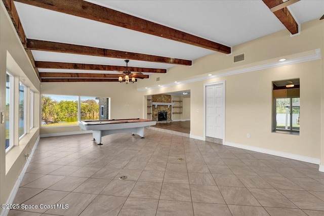 playroom featuring beamed ceiling, light tile patterned floors, a fireplace, and billiards