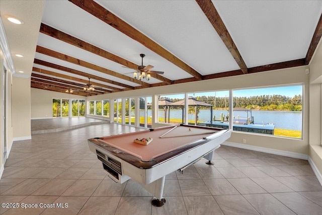 rec room with beamed ceiling, light tile patterned flooring, and a water view