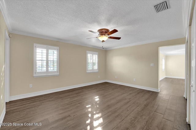 empty room with crown molding, ceiling fan, dark wood-type flooring, and a textured ceiling