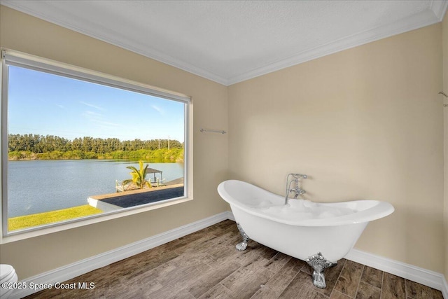 bathroom with hardwood / wood-style flooring, ornamental molding, a water view, and a bathtub