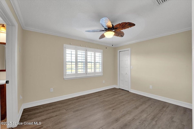 spare room with hardwood / wood-style flooring, crown molding, a textured ceiling, and ceiling fan