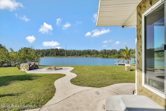 view of yard featuring a water view and a patio area