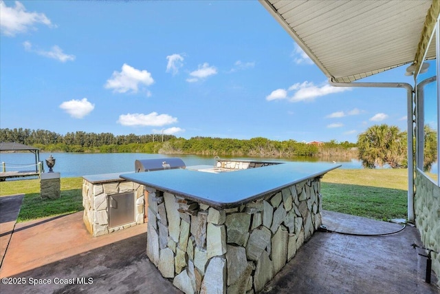 view of patio with a bar and a water view