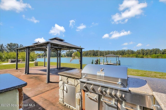 view of patio / terrace with a gazebo, exterior kitchen, and a water view