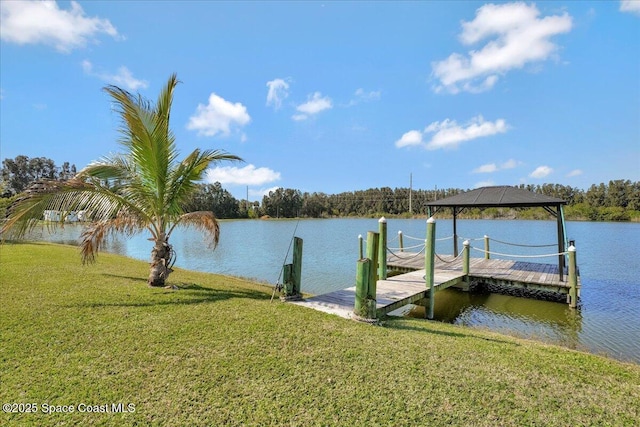 dock area with a gazebo, a water view, and a yard