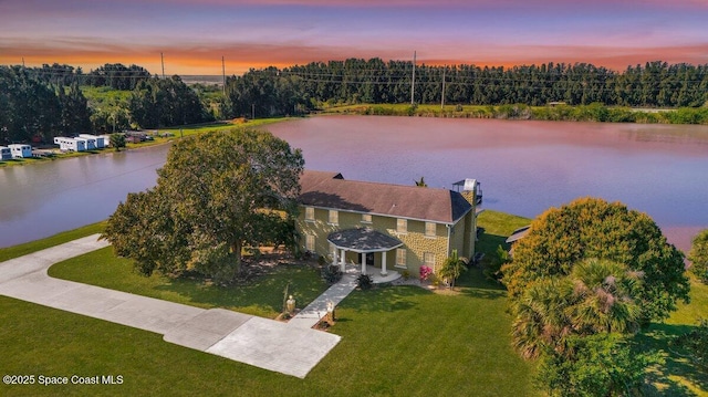 aerial view at dusk with a water view