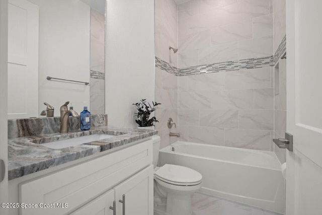 full bathroom with toilet, vanity, and tiled shower / bath