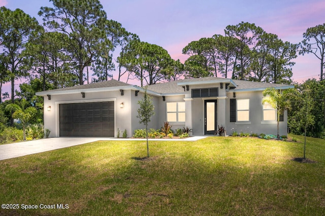 view of front facade featuring a garage and a lawn