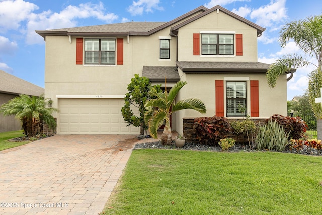 view of front of house with a garage and a front yard