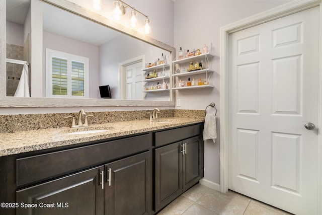 bathroom with tile patterned floors, vanity, and an enclosed shower